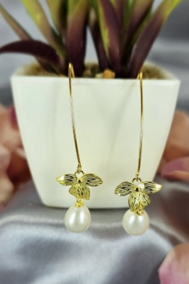 Gold long drop flower looking earrings with freshwater pearl on end