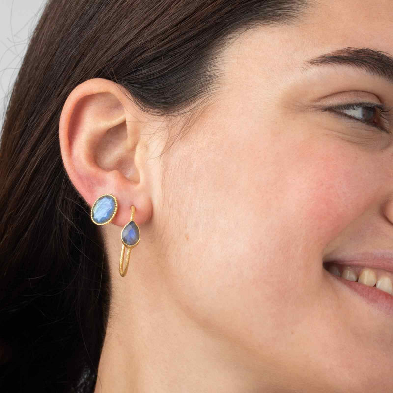 Gold hoop earrings with emerald teardrop stones