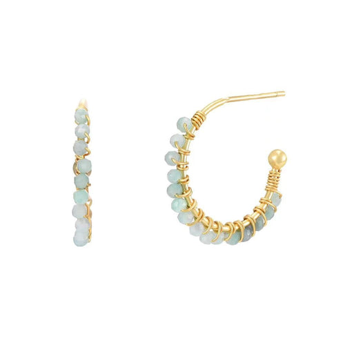 Gold hoop earrings with light blue beads on a white background