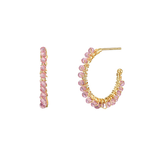 Gold hoop earrings with pink beads on a white background