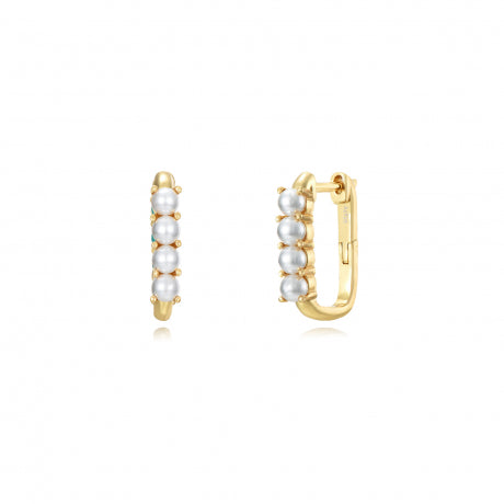 Gold hoop earrings with pearls on a white background