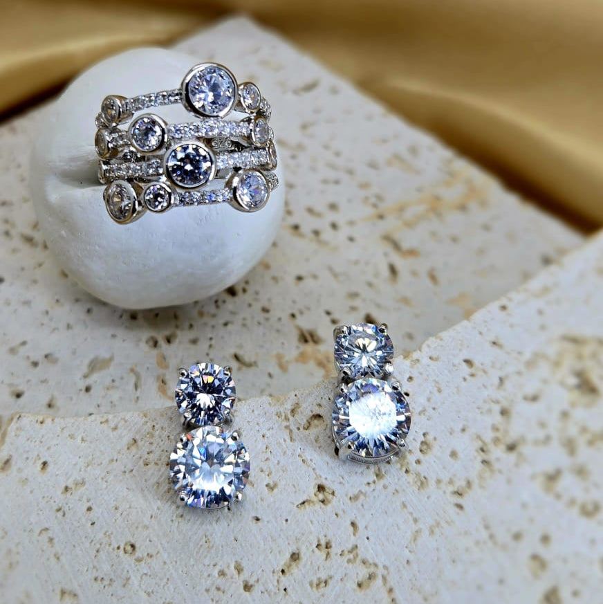 Set of silver rings with gemstones on a textured surface