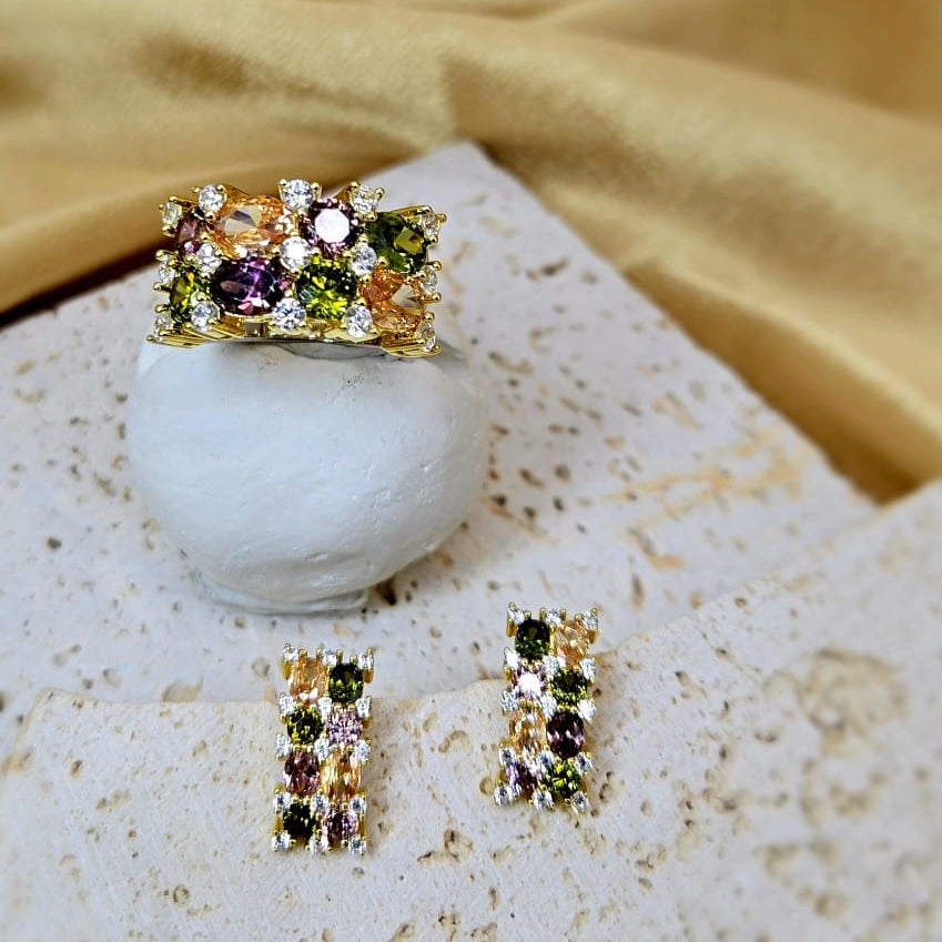 Jewelry set with ring and earrings on a textured surface