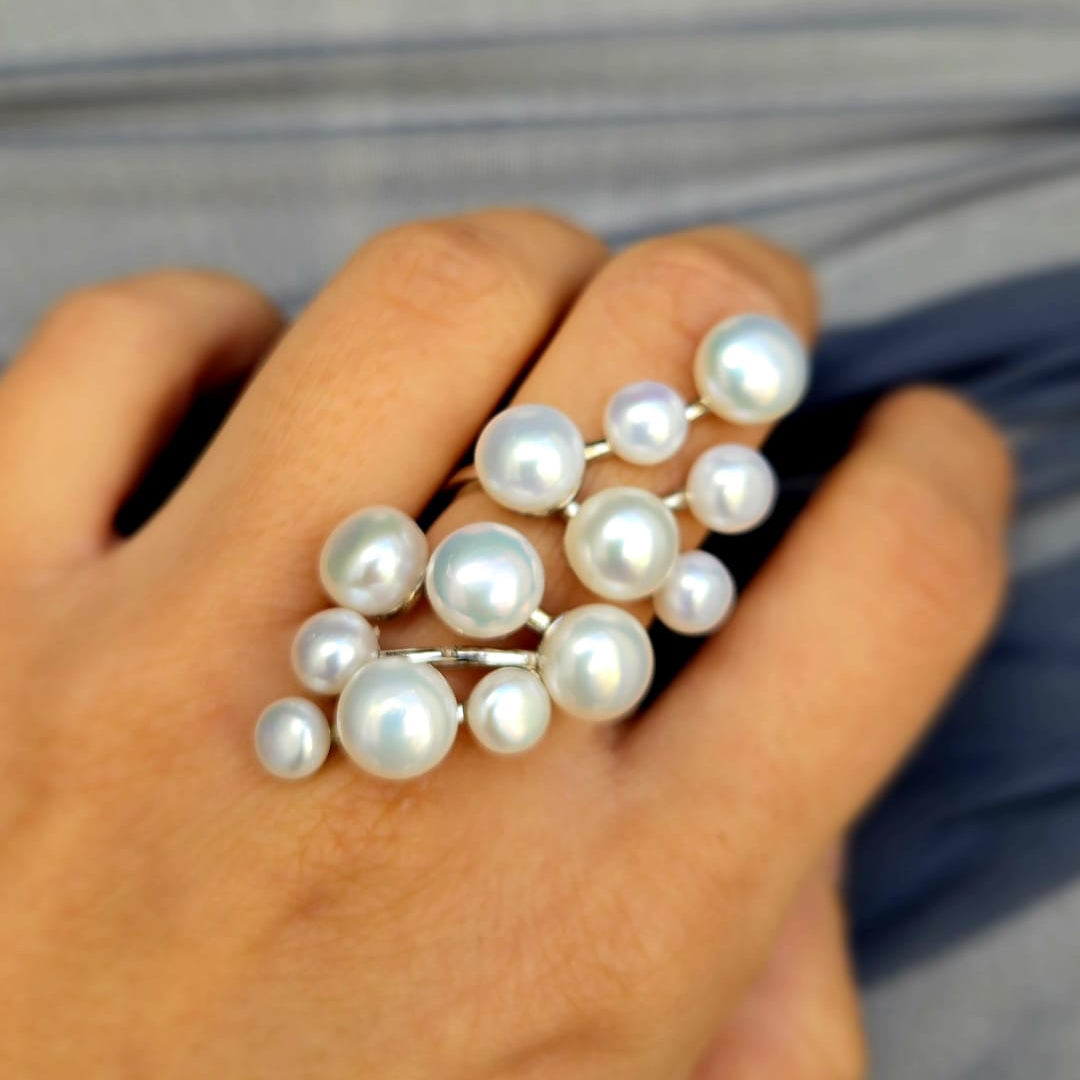 Pearl ring on a hand with a blurred background