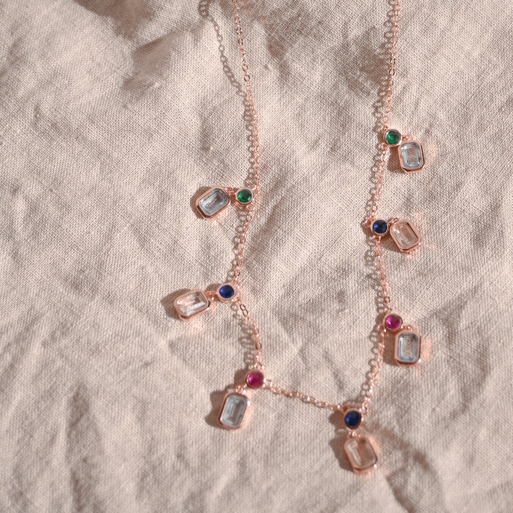 Rose gold necklace with pastel coloured dangly stones