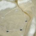 Close-up of a beige fabric with a decorative chain and stones.
