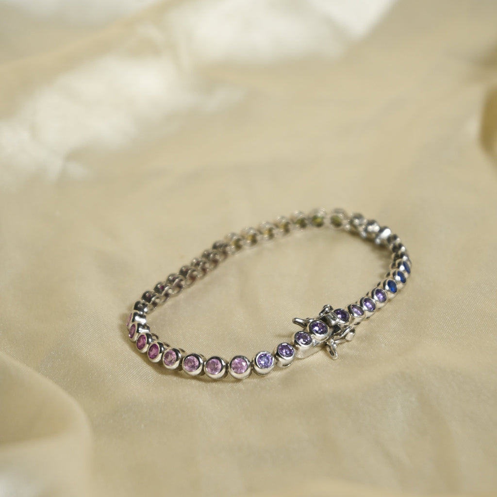 Bracelet with purple stones on a beige fabric background
