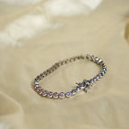 Bracelet with purple stones on a beige fabric background