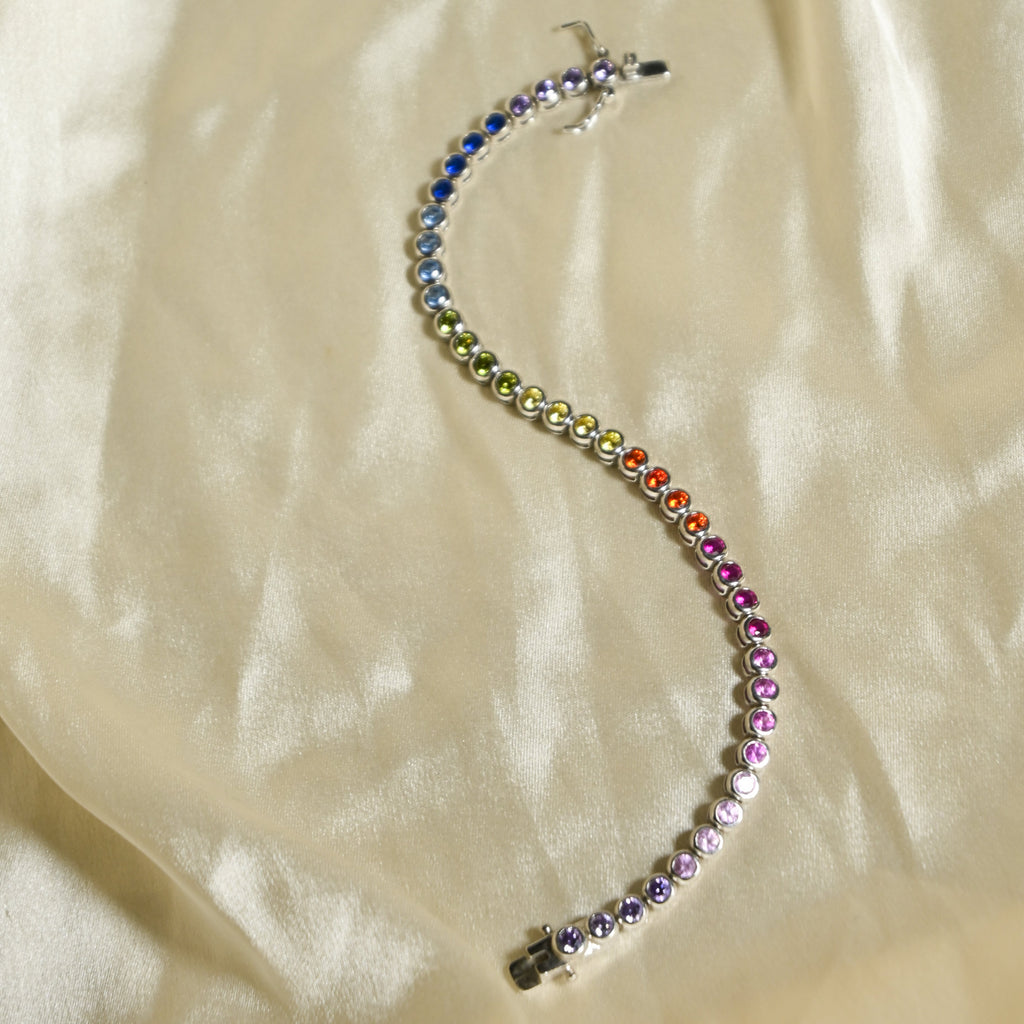 Multicolored beaded bracelet on a beige fabric background