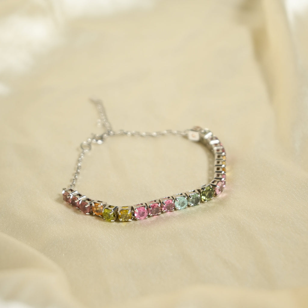 Multicolored gemstone bracelet on a beige fabric background