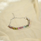 Multicolored gemstone bracelet on a beige fabric background