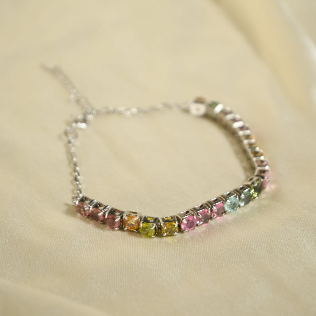 Multicolored gemstone bracelet on a soft beige background