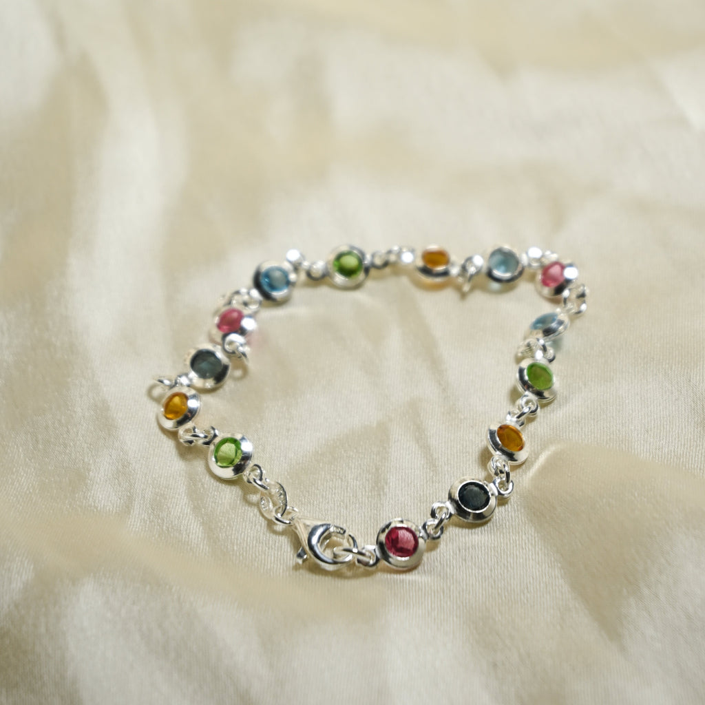Multicolored beaded bracelet on a soft beige fabric background