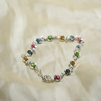 Multicolored beaded bracelet on a soft beige fabric background