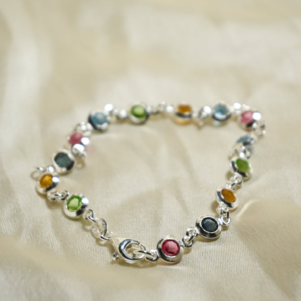 Multicolored beaded bracelet on a beige fabric background