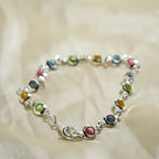 Multicolored beaded bracelet on a beige fabric background
