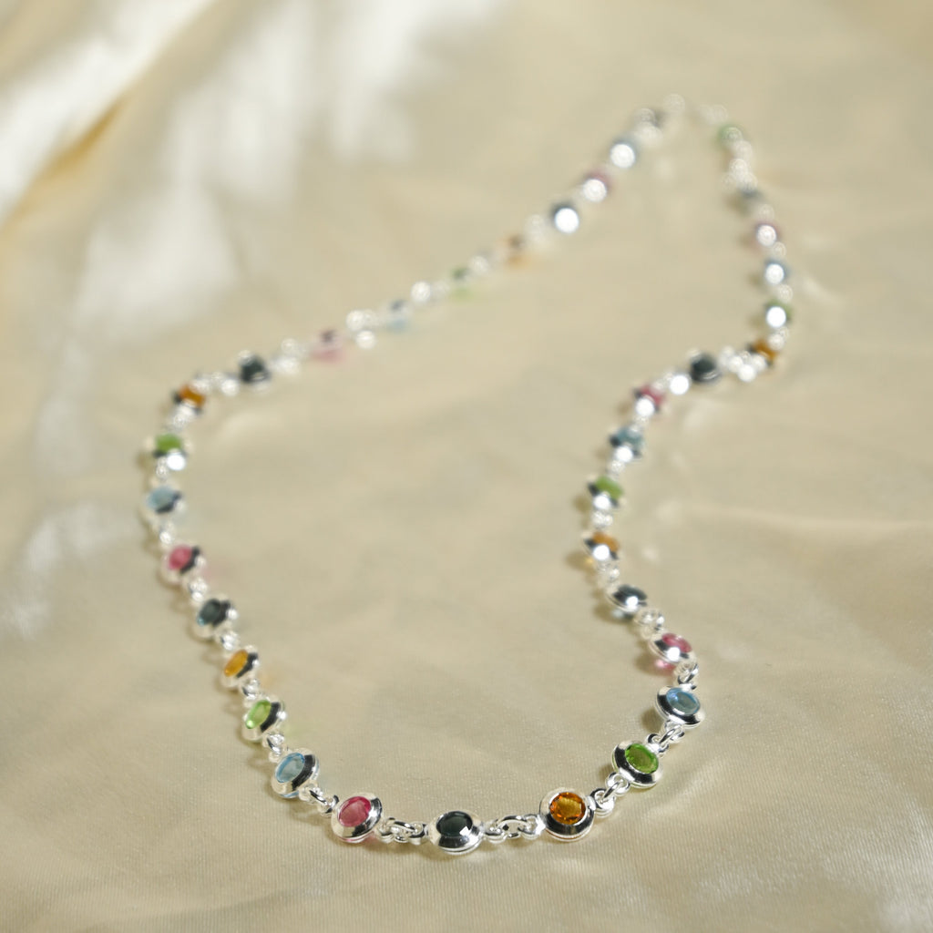 Necklace with multicolored beads on a beige fabric background