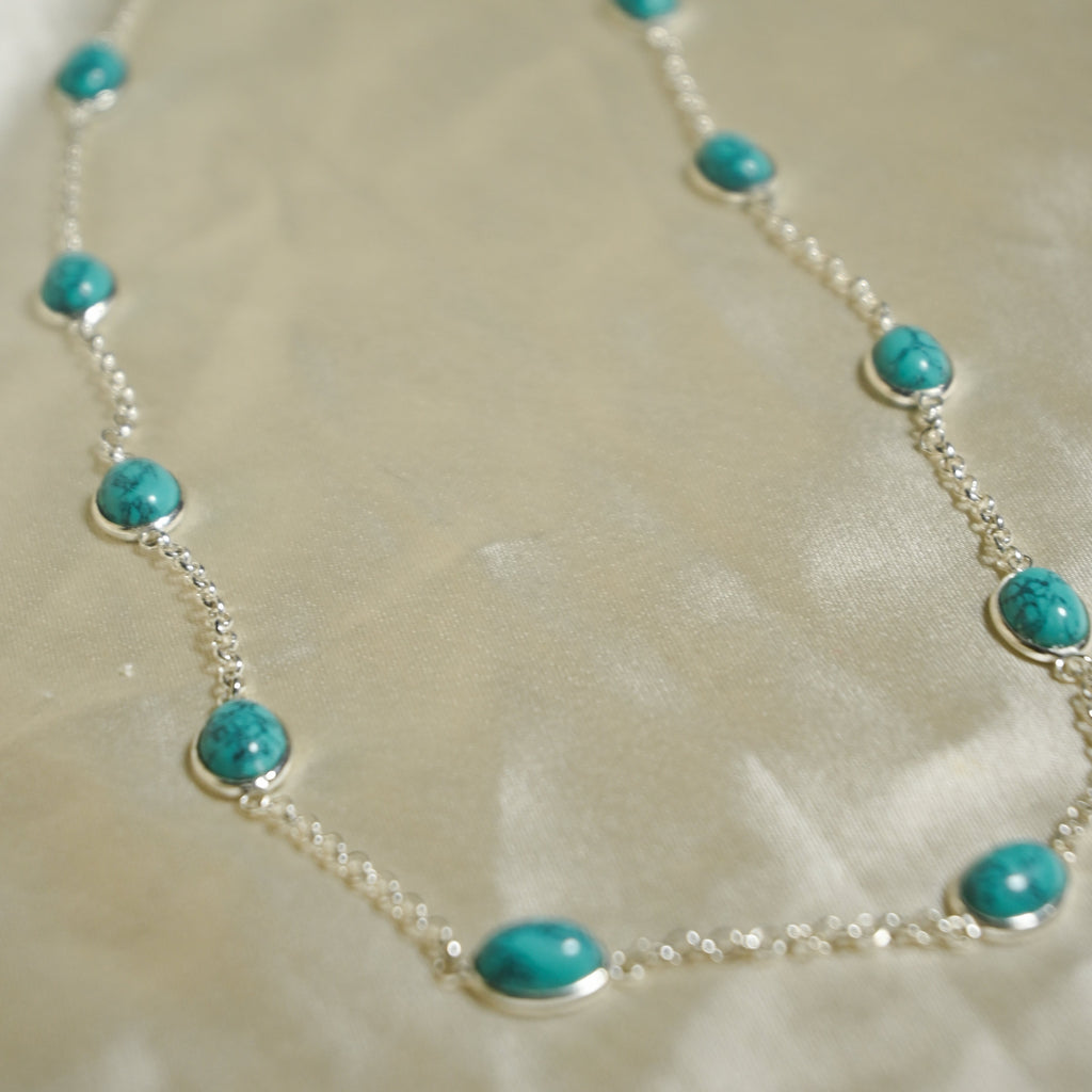 Necklace with turquoise beads on a beige background