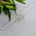 A sterling silver bracelet featuring a large lotus flower design, with a chain structure and a lobster clasp closure.