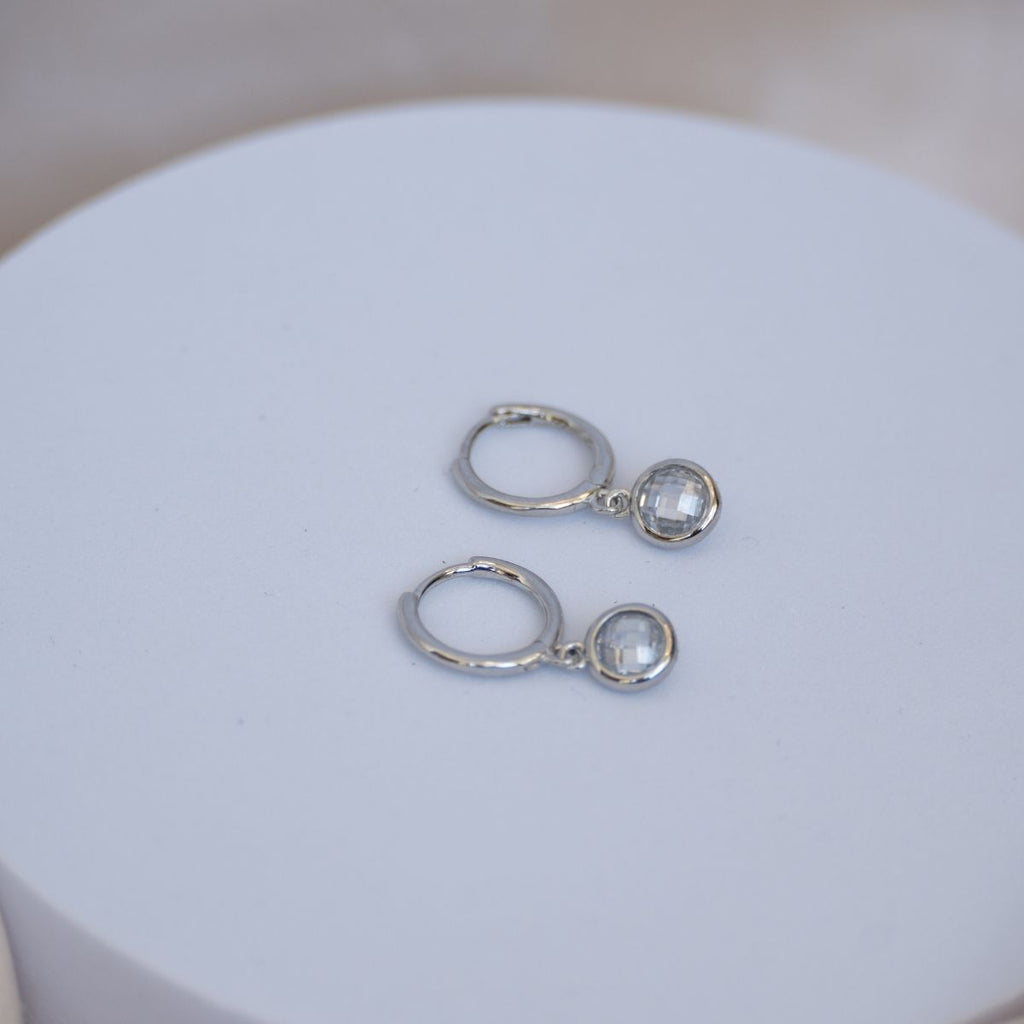 Huggy earrings with dangly cubic zirconia stones - Terciany 