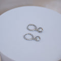 Huggy earrings with dangly cubic zirconia stones - Terciany 