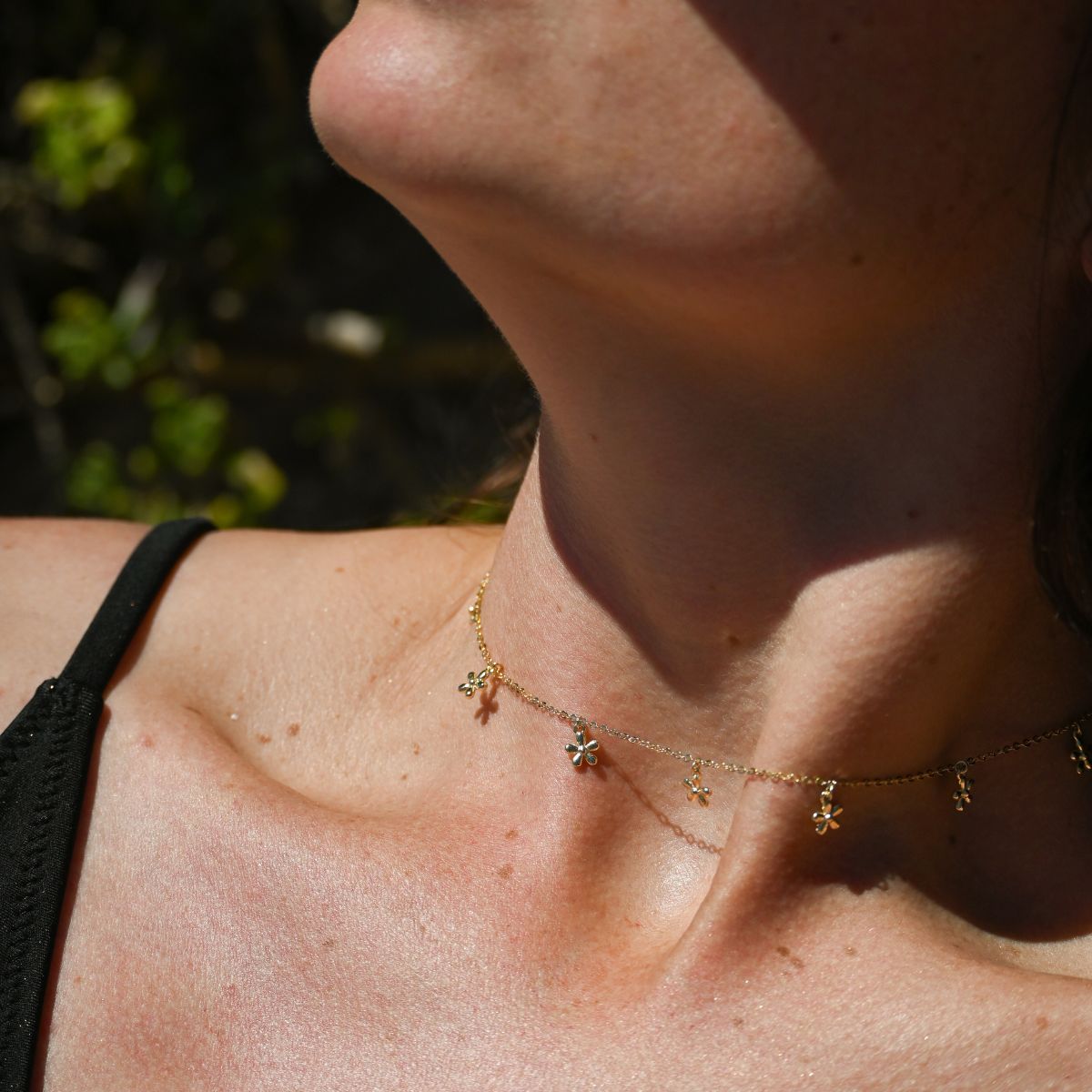 Gold necklace with lots of flowers in chain