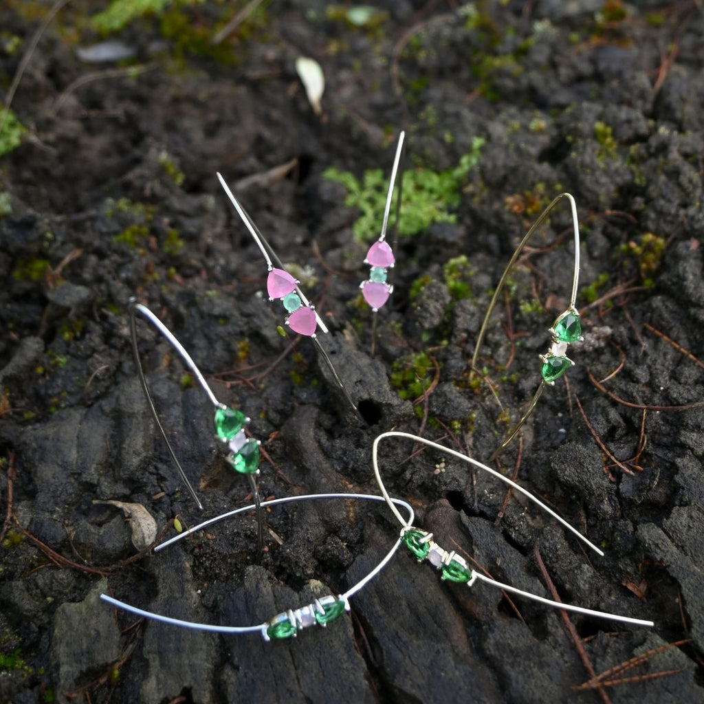 Set of beaded hair clips on a dark, textured surface with green and pink beads.