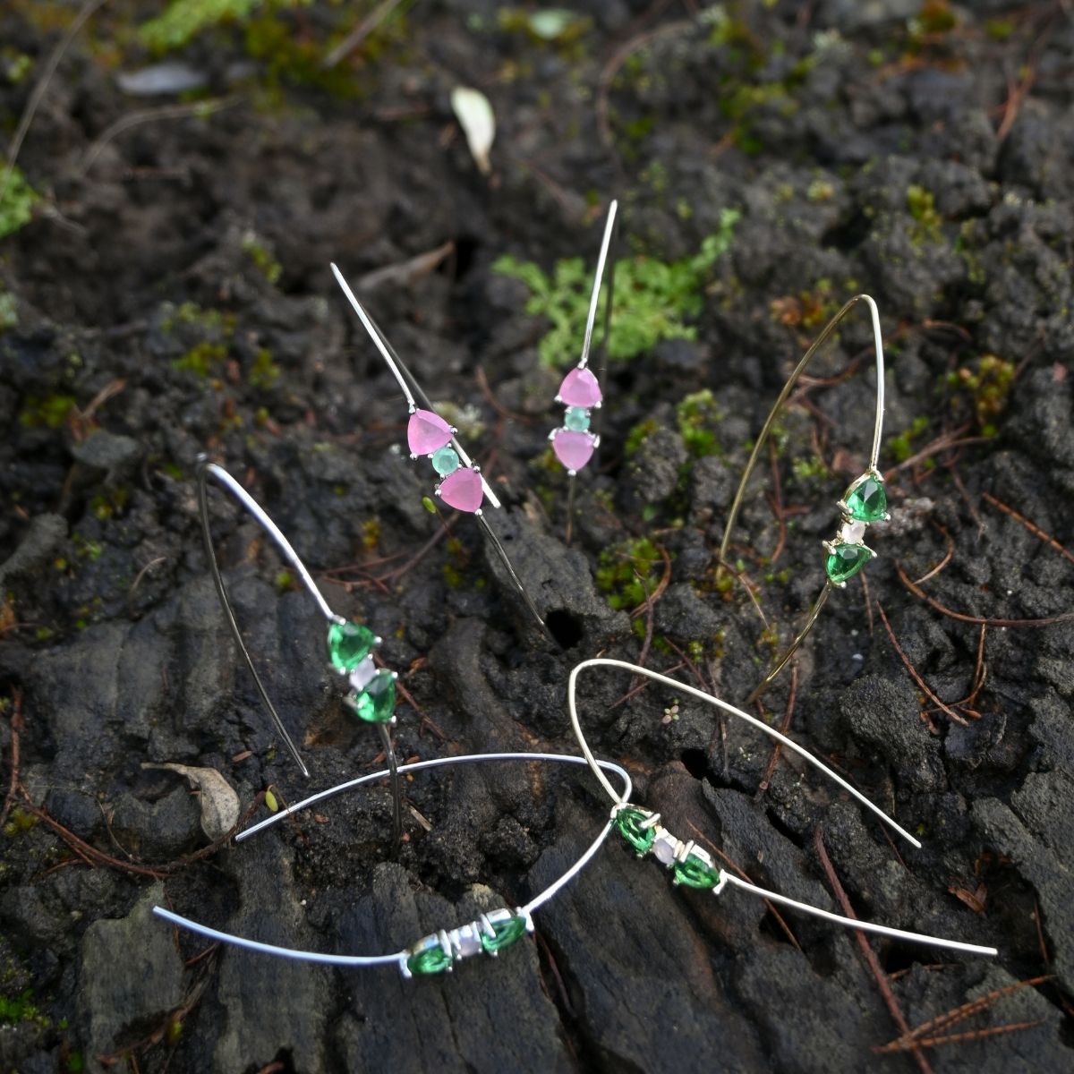 Set of beaded hair clips on a dark, textured surface with green and pink beads.