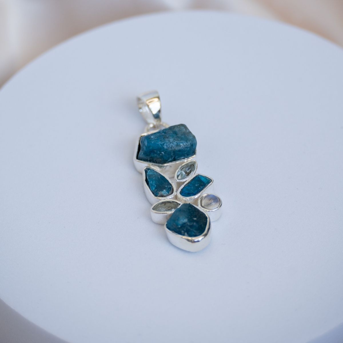 Pendant with a cluster of Raw Blue apatite and other light semi precious stones