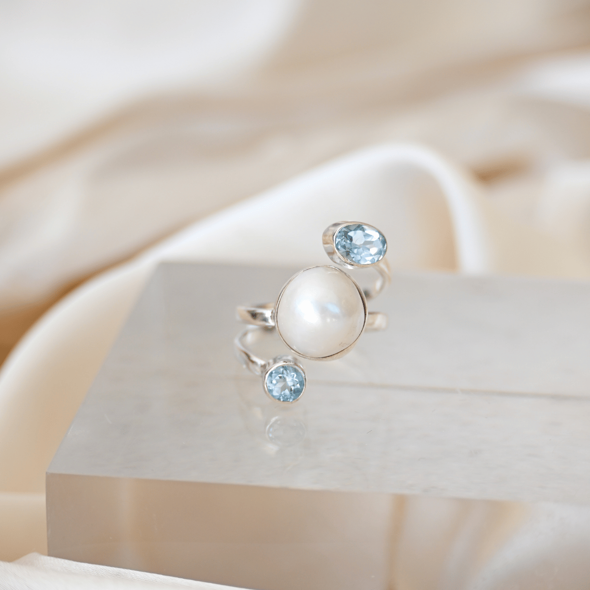 Sterling silver freshwater pearl ring with two blue topaz semi precious stones