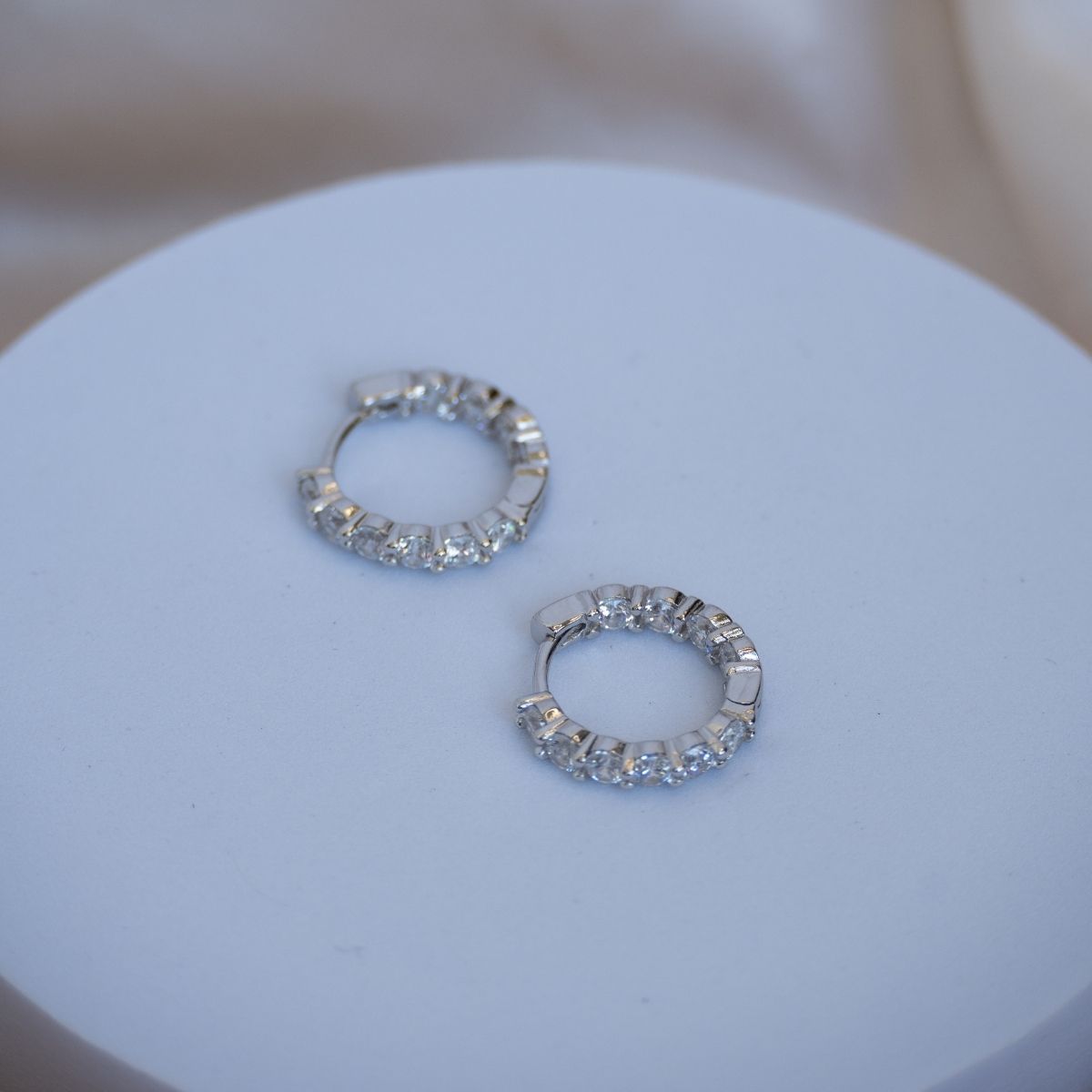 Silver Huggy earrings with Zirconia detail on front sides