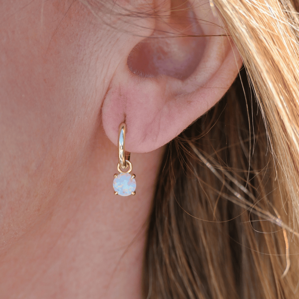 Gold huggy earring with Opal charm
