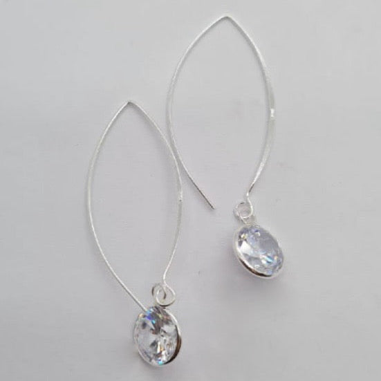 A pair of sterling silver hoop earrings with round cubic zirconia drops.
